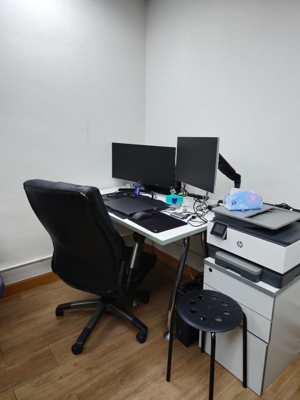 A fixed desk setup at MTC Workspace with dual monitors and chair